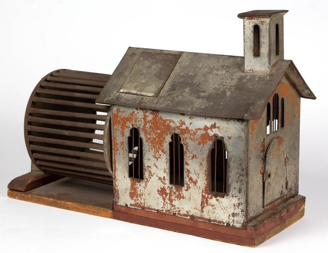AMERICAN FOLK ART TIN AND WOOD SQUIRREL CAGE: AMERICAN FOLK ART TIN AND WOOD SQUIRREL CAGE, in the form of a church, with hinged door. Retains an old red-painted surface. Fourth quarter 19th century. 19" HOA, 27 1/4" W, 9" D. Very good overall co