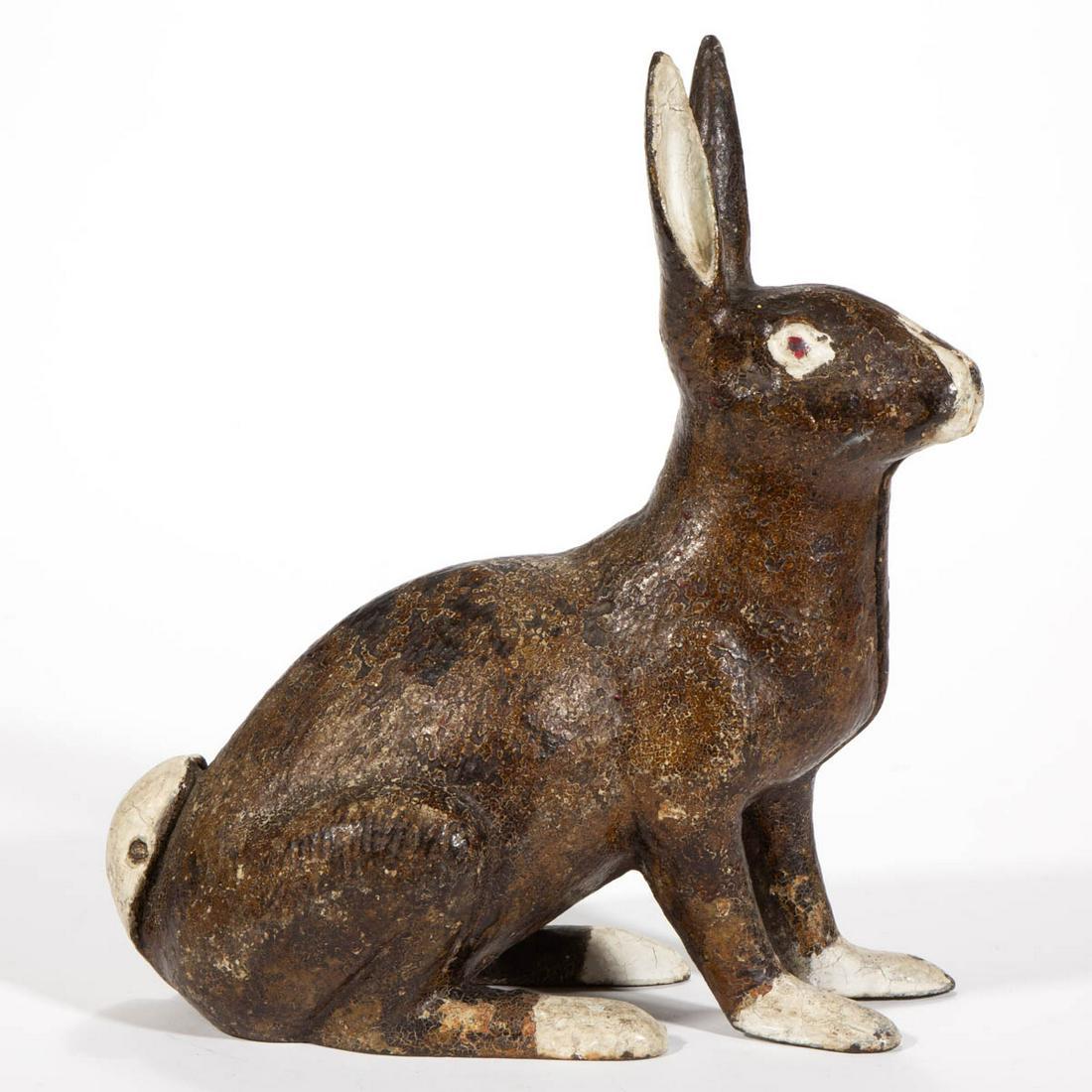 AMERICAN CAST-IRON PAINTED FIGURAL RABBIT DOORSTOP: AMERICAN CAST-IRON PAINTED FIGURAL RABBIT DOORSTOP, two-piece construction, full-body seated form, no markings located. Retains an old polychrome-painted surface. First quarter 20th century. 12" H. Ve