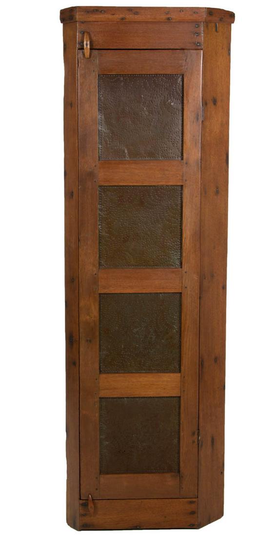 AMERICAN COUNTRY WALNUT PUNCHED-TIN CORNER FOOD / PIE: AMERICAN COUNTRY WALNUT PUNCHED-TIN CORNER FOOD / PIE SAFE, applied simple cornice, above hinged door set with four tins with geometric designs. Old refinished surface with warm color. 19th century. 7