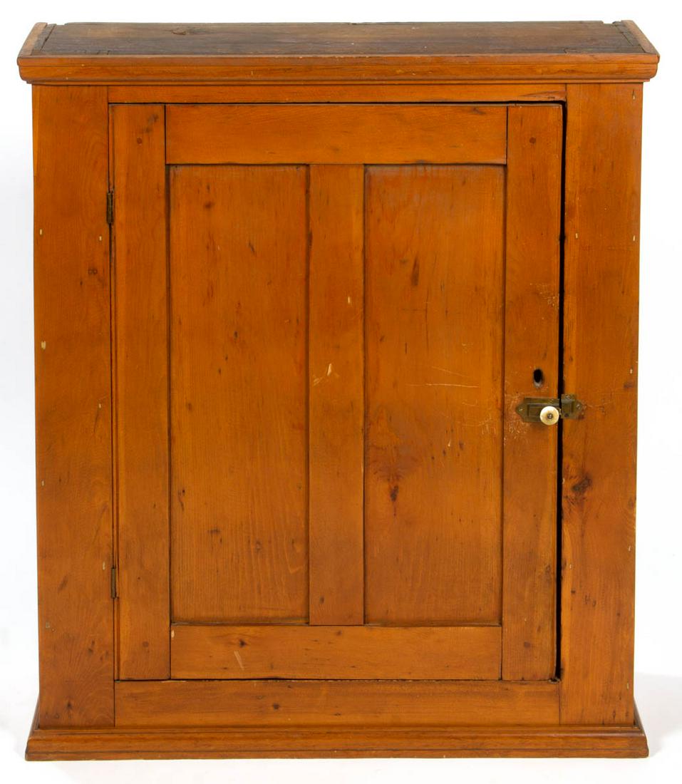 AMERICAN COUNTRY PINE HANGING CUPBOARD: AMERICAN COUNTRY PINE HANGING CUPBOARD, applied molded cornice, above single hinged panelled door concealing three fixed shelves, and lower applied base moldings. Yellow pine secondary. Old refinished