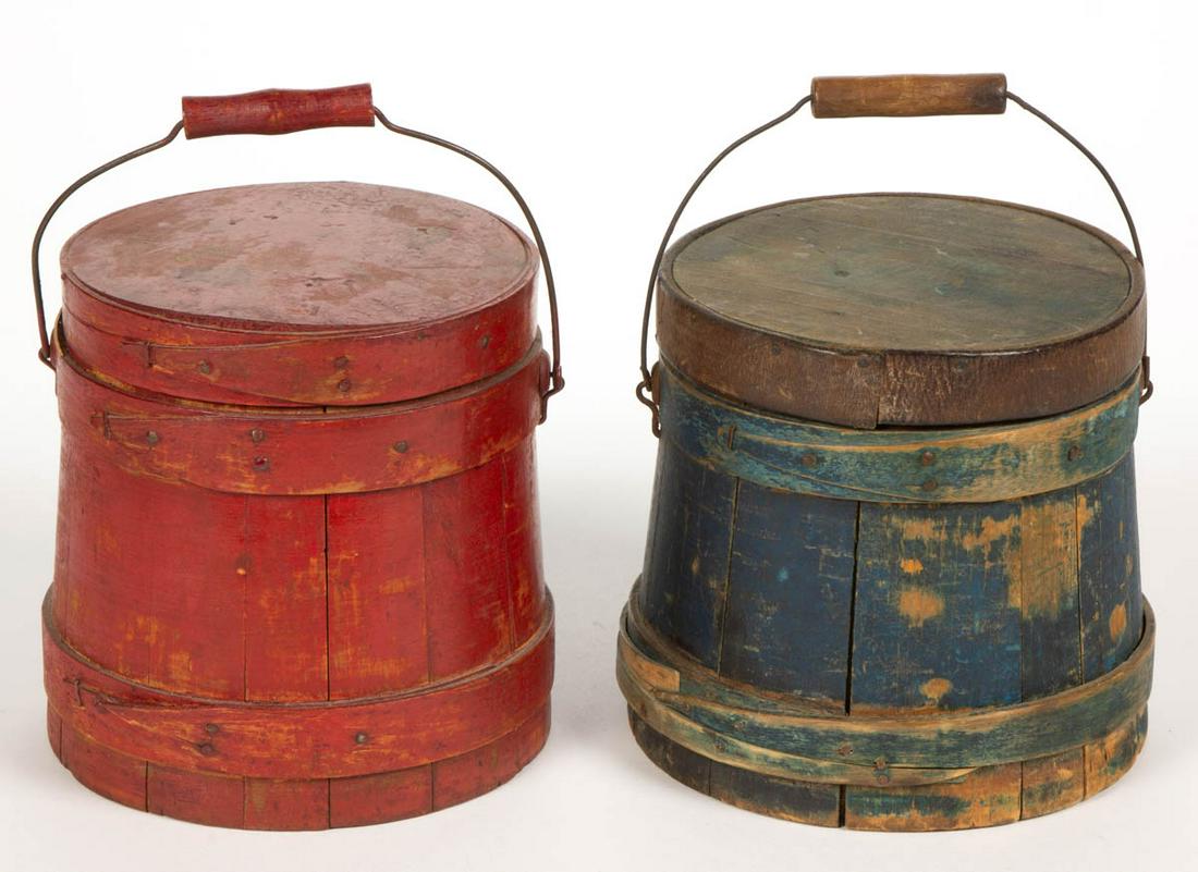 AMERICAN PAINTED TREEN SUGAR BUCKETS / FIRKINS, LOT OF: AMERICAN PAINTED TREEN SUGAR BUCKETS / FIRKINS, LOT OF TWO, with wire bail handles. Retains an old blue and red-painted surface. 19th century. 6 1/2" and 6 3/4" H.Blue example with old leather make-do
