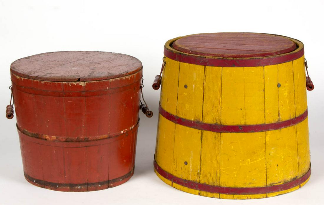 AMERICAN PAINTED TREEN BUCKETS, LOT OF TWO: AMERICAN PAINTED TREEN BUCKETS, LOT OF TWO, each with cover, staves secured with metal bands, and applied wire bail handles. Retains an old red -and - yellow-painted surface. Late 19th/early 20th cent