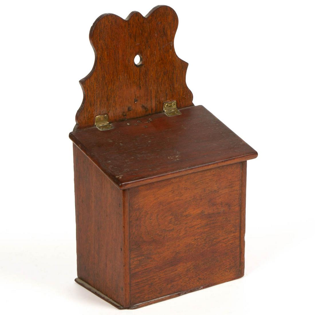 BRITISH MAHOGANY WALL BOX: BRITISH MAHOGANY WALL BOX, nailed construction, with shaped back board and original brass hinges. Old surface. First half 19th century. 14 1/2" HOA, 8 1/2" WOA, 5 1/4" DOA. Good overall condition with