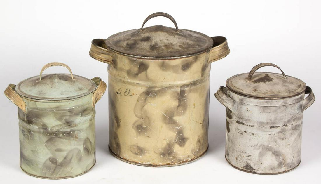 SET OF THREE PAINT-DECORATED TIN GENERAL STORE: SET OF THREE PAINT-DECORATED TIN GENERAL STORE CANISTERS, each cylindrical covered form retaining likely original smoke-decorated surface, one inscribed "2 lb." Late 19th/early 20th century. 8 1/2" HO