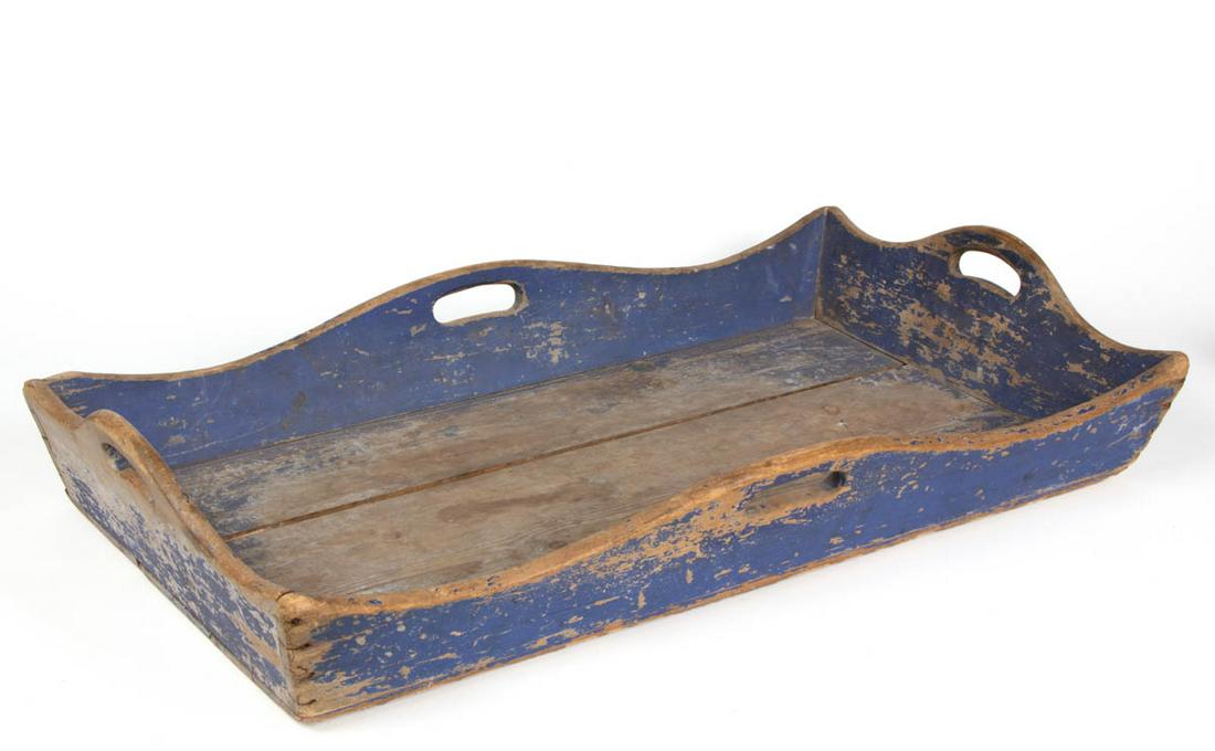 COUNTRY PAINTED PINE TRAY: COUNTRY PAINTED PINE TRAY, rectangular form with canted sides, shaped edges, and cut-out handles. Old blue-painted surface. Second half 19th century. 4 1/2" H, 29" L, 16 3/4" W.Very good overall condi