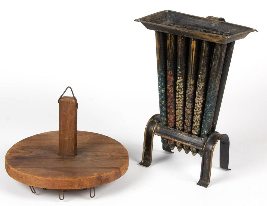 AMERICAN COUNTRY LIGHTING ACCESSORIES, LOT OF TWO: AMERICAN COUNTRY LIGHTING ACCESSORIES, LOT OF TWO, comprising treen candle dipper, and paint-decorated tin candle mold. 19th century. Candle Mold 12" H. Very good overall condition, with scattered min
