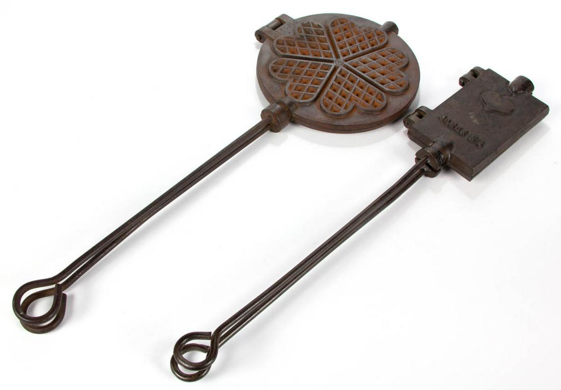 AMERICAN CAST-IRON PICTORIAL WAFER IRONS, LOT OF TWO: AMERICAN CAST-IRON PICTORIAL WAFER IRONS, LOT OF TWO, comprising one embossed "COEUR N 4", and a heart-form example stamped "PW 22 BIS". First half 20th century. 23" and 25" L.Very good overall condit