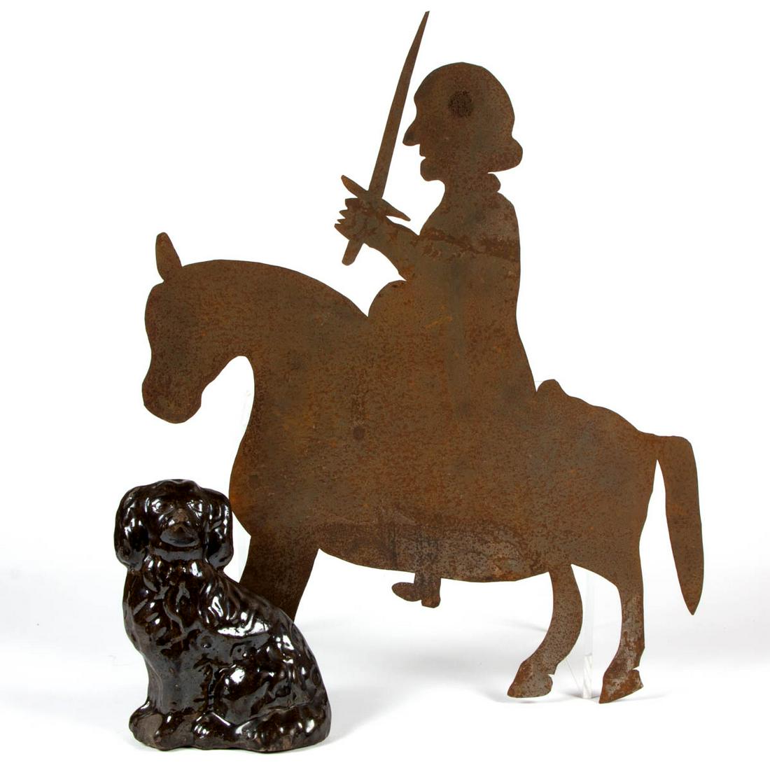 ASSORTED COUNTRY ARTICLES, LOT OF TWO: ASSORTED COUNTRY ARTICLES, LOT OF TWO, comprising an Albany-glazed stoneware seated Spaniel figure, and a cut-out sheet-iron figure of a man with sword riding a horse. Spaniel and bellows 19th century