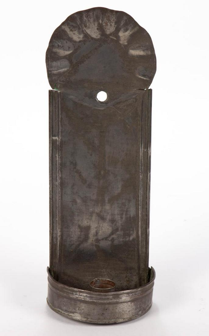 LEESBURG, VIRGINIA SHEET-IRON / TIN WALL CANDLE SCONCE: LEESBURG, VIRGINIA SHEET-IRON / TIN WALL CANDLE SCONCE, crimped edge to arched top, and semi-circle drip pan with single socket, stamped on the reverse "FROM / W.H. THOMAS / LEESBURG, VA". 19th centur
