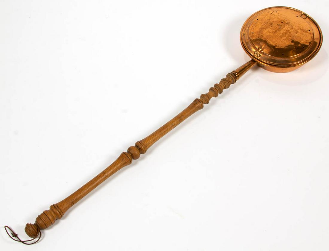 ANTIQUE COPPER BED WARMER: ANTIQUE COPPER BED WARMER, with oak handle. 19th century. 48 1/4" LOA.Good overall condition, moderate separation of applied handle, and with areas of expected usage wear.Provenance: From the Hunter a