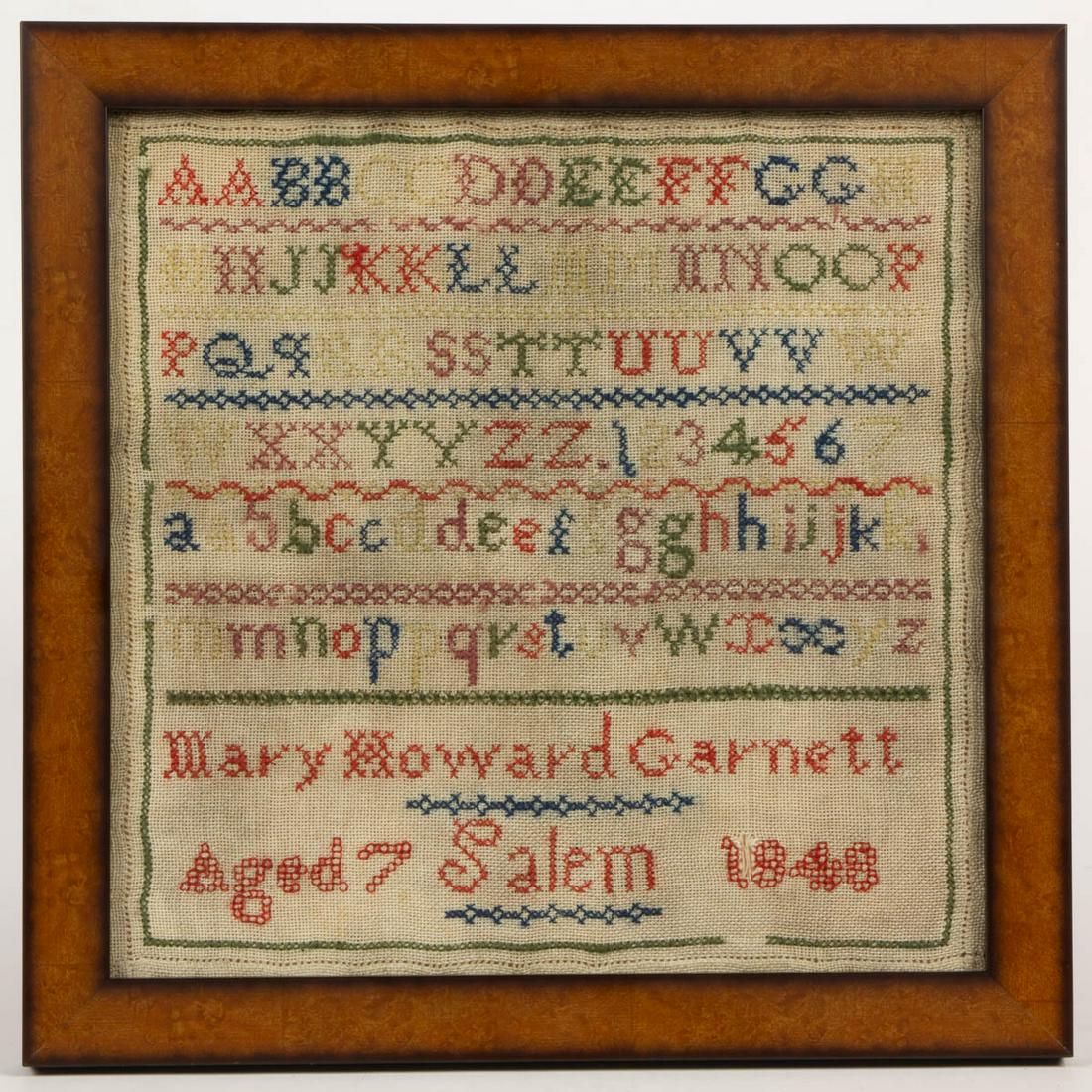 AMERICAN / BRITISH NEEDLEWORK SAMPLER: AMERICAN / BRITISH NEEDLEWORK SAMPLER, wool on linen, six alphabet and numeral rows segmented by horizontal bands of decorative stitching, below signed and dated "Mary Howard Garnett / Aged 7 Salem 18