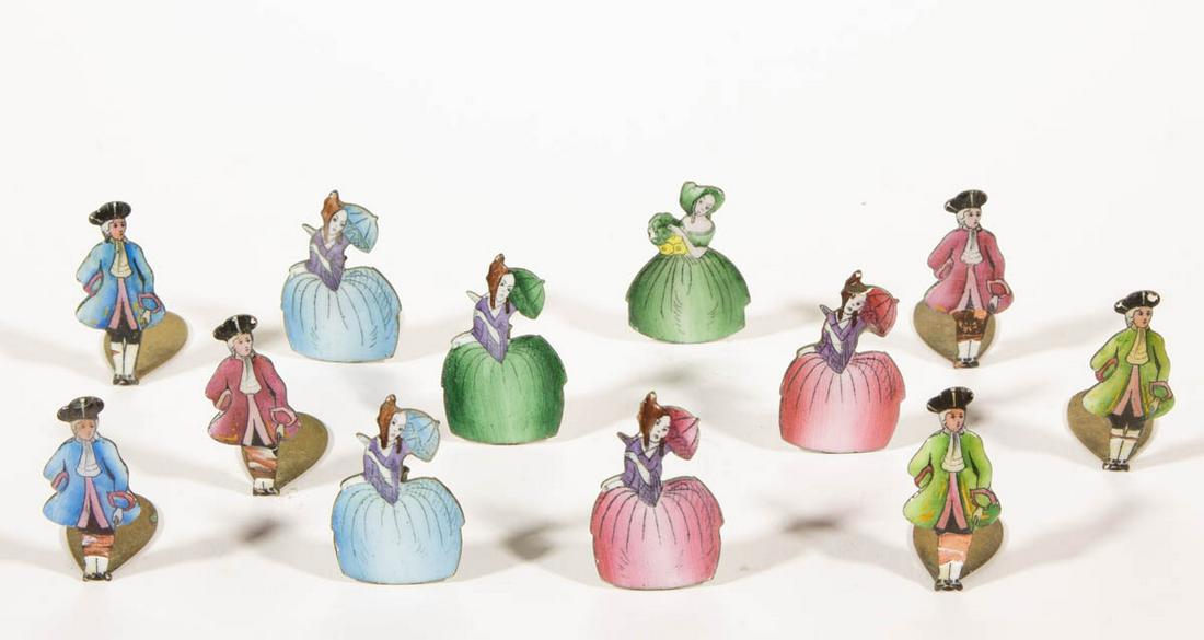 FIGURAL ENAMELED-BRASS PLACECARD HOLDERS, SET OF 12: FIGURAL ENAMELED-BRASS PLACECARD HOLDERS, SET OF 12, depicting six female and six male standing figures, each dressed in Colonial garb. First quarter 20th century. 1 3/8" HOA.Several men with losses t