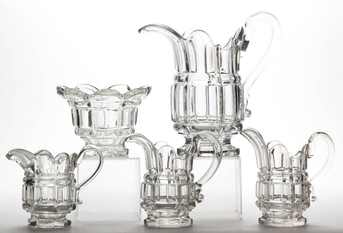 BLOCK AND BAR ARTICLES, LOT OF FIVE: BLOCK AND BAR ARTICLES, LOT OF FIVE, colorless lead glass, comprising a water pitcher, three creamers, and a waste bowl. Maker unverified. 1850-1870. 4 1/4" to 8 3/4" HOA. Water pitcher having a crack
