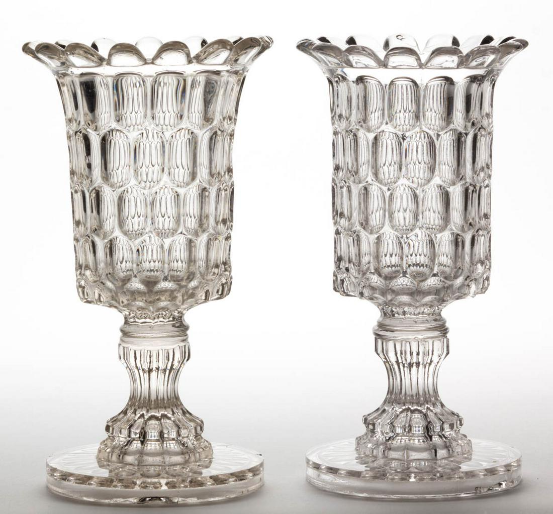 EARLY THUMBPRINT / ARGUS (OMN) CELERY VASES, LOT OF TWO: EARLY THUMBPRINT / ARGUS (OMN) CELERY VASES, LOT OF TWO, colorless lead glass, wafer construction. Bakewell, Pears & Co., Pittsburgh, PA. Third quarter 19th century. 9 1/4" H. Each having a moderate c