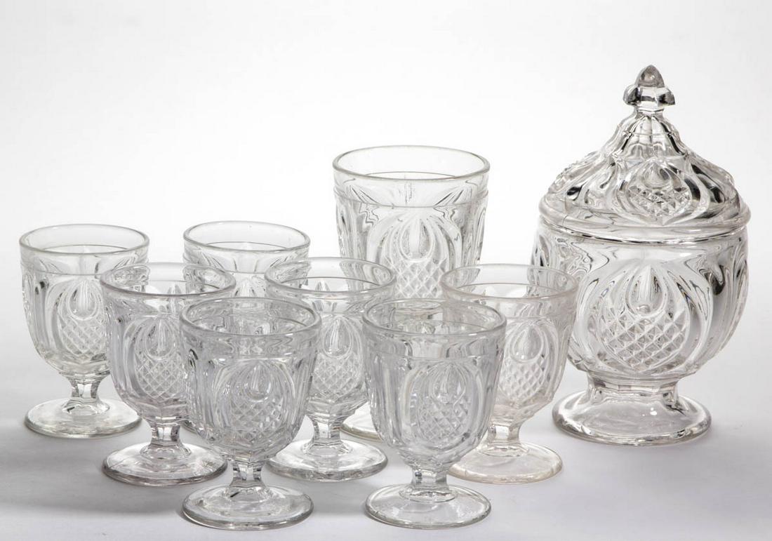 NEW ENGLAND PINEAPPLE ARTICLES, LOT OF NINE: NEW ENGLAND PINEAPPLE ARTICLES, LOT OF NINE, colorless lead glass, comprising a covered sugar bowl, goblet, and seven egg cups. Boston & Sandwich Glass Co. and others. Third quarter 19th century. 3 3/