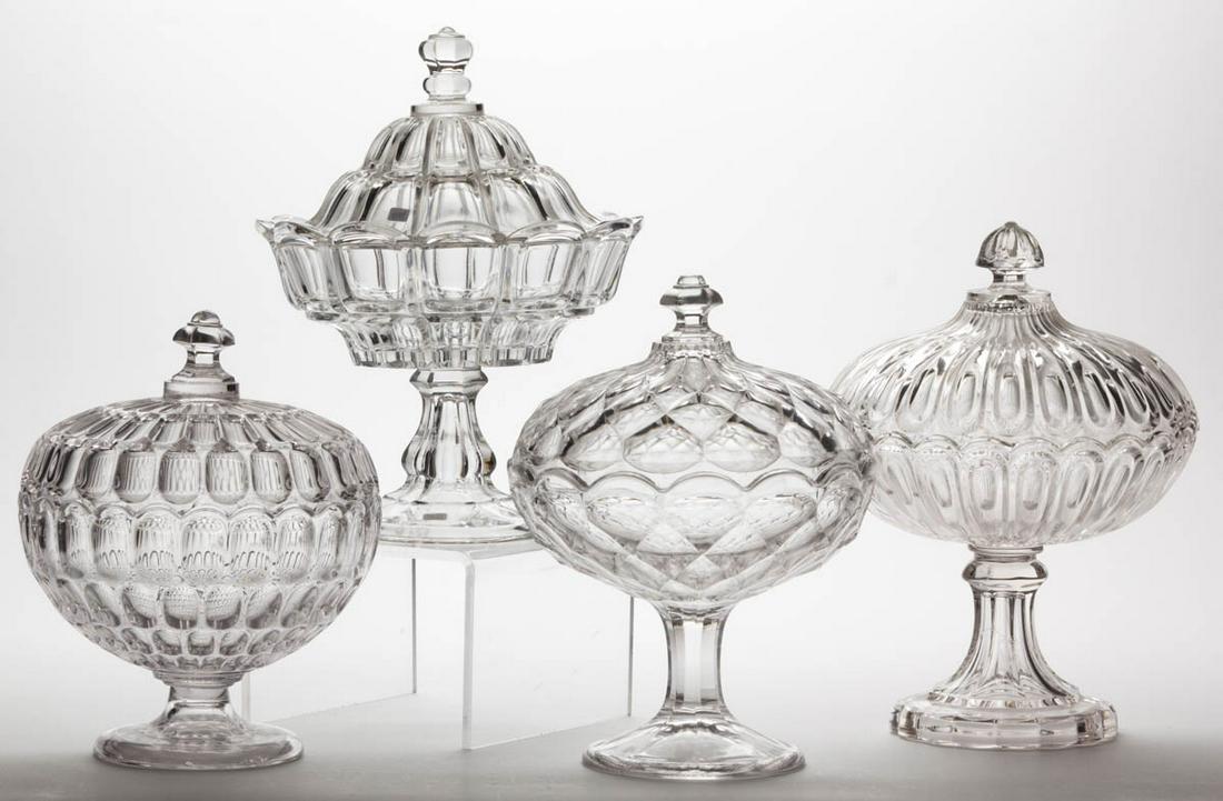 ASSORTED FLINT EAPG COVERED COMPOTES, LOT OF FOUR: ASSORTED FLINT EAPG COVERED COMPOTES, LOT OF FOUR, colorless lead glass, comprising a Bigler, a Smocking, a Hairpin, and an Early Thumbprint. Various makers. Third quarter 19th century. 9" to 10 3/4" 