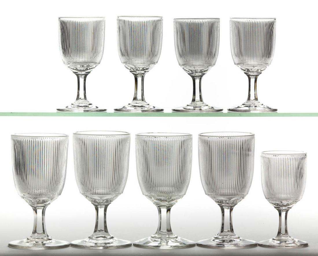 FINE RIB / REEDED (OMN) DRINKING ARTICLES, LOT OF NINE: FINE RIB / REEDED (OMN) DRINKING ARTICLES, LOT OF NINE, colorless lead glass, comprising four goblets and five champagnes. Boston & Sandwich Glass Co., New England Glass Co., and possibly others. Thir