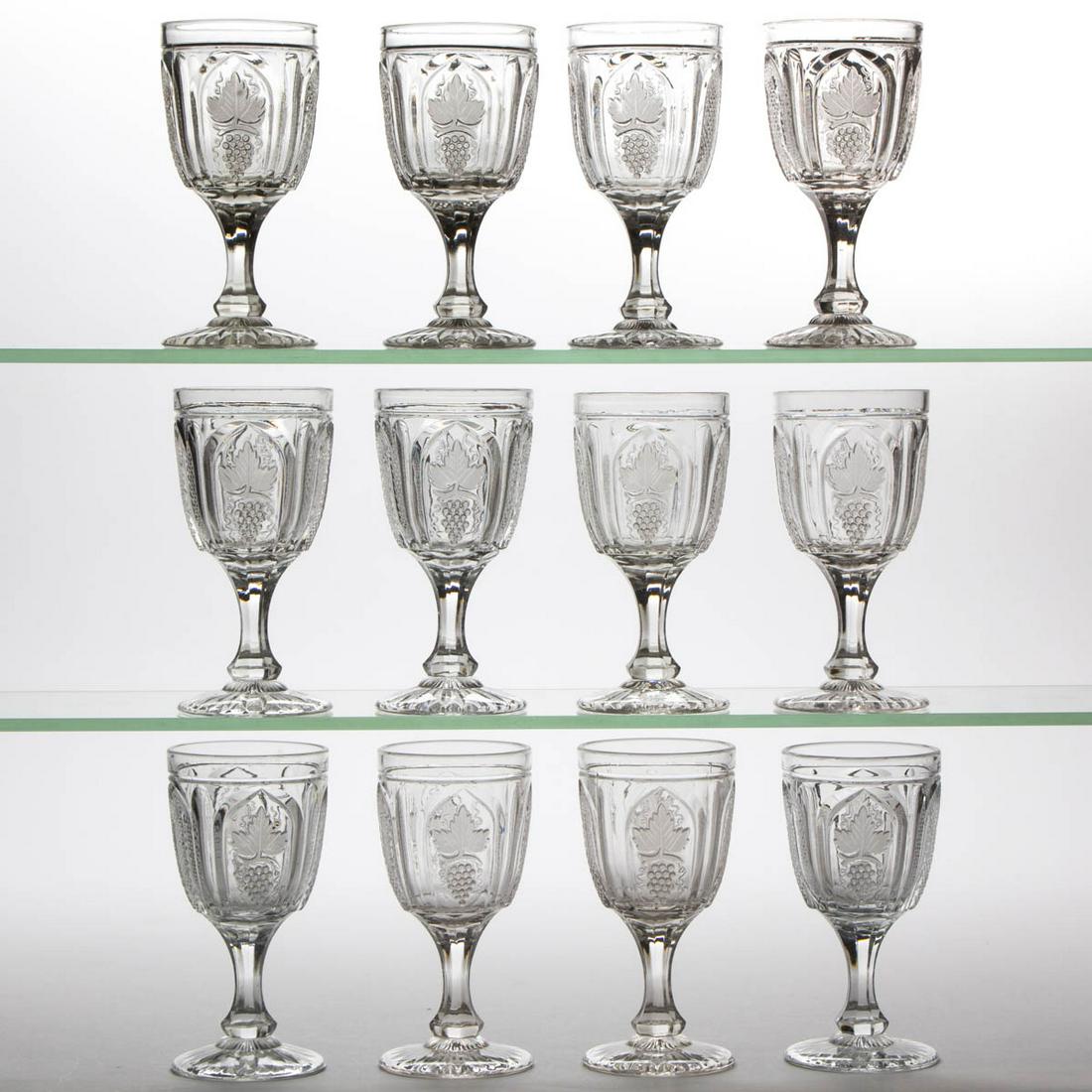 MAGNET AND GRAPE WITH FROSTED LEAF CHAMPAGNES, LOT OF: MAGNET AND GRAPE WITH FROSTED LEAF CHAMPAGNES, LOT OF 12, colorless lead glass. Boston & Sandwich Glass Co. and possibly others. 1855-1870. 5 1/4" H. One champagne with a pattern bruise; remainder und