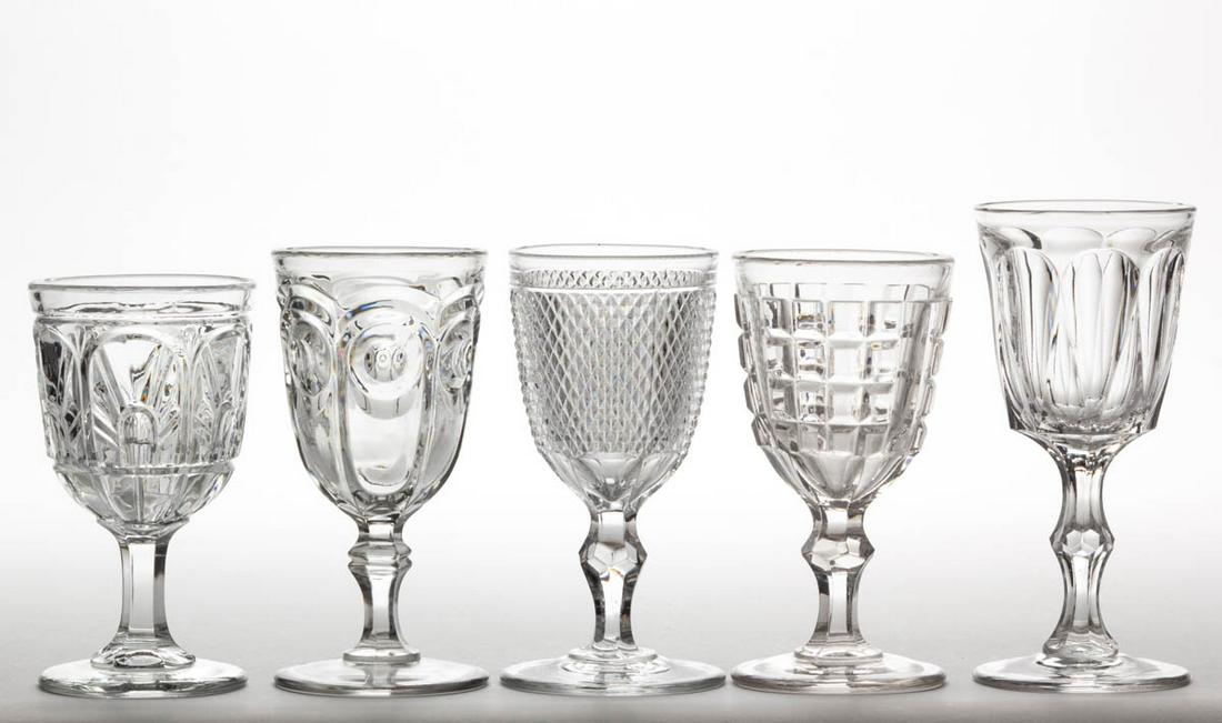 ASSORTED FLINT EAPG CHAMPAGNES, LOT OF FIVE: ASSORTED FLINT EAPG CHAMPAGNES, LOT OF FIVE, colorless lead glass, comprising a Lee, Gothic, Bull's Eye, Diamond Point, and Panelled Waffle. Various makers. Third quarter 19th century. 5" to 6" H. Dia