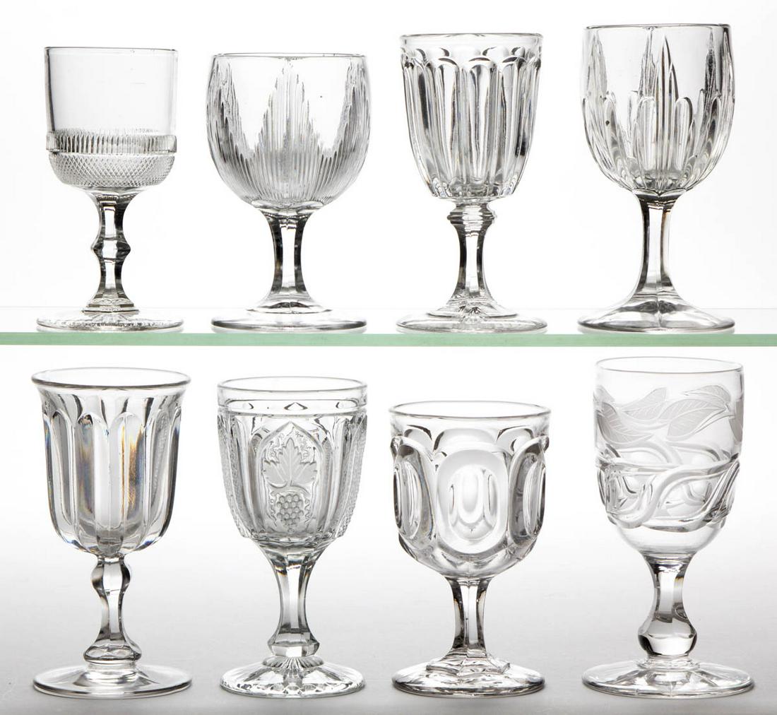 ASSORTED FLINT EAPG CHAMPAGNES, LOT OF EIGHT: ASSORTED FLINT EAPG CHAMPAGNES, LOT OF EIGHT, colorless lead glass, including a Stedman, a Magnet and Grape, an Icicle, and an Oval Eye Frosted Leaf variant. Various makers. Third quarter 19th century
