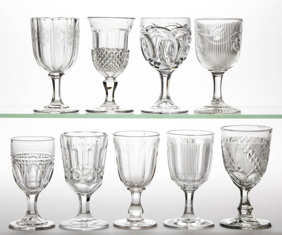 ASSORTED FLINT EAPG CHAMPAGNES, LOT OF NINE: ASSORTED FLINT EAPG CHAMPAGNES, LOT OF NINE, colorless lead glass, including a Ribbed Ivy, Wedding Rings, Diagonal Sawtooth Band, and a Panelled Finetooth. Various makers. Third quarter 19th century.