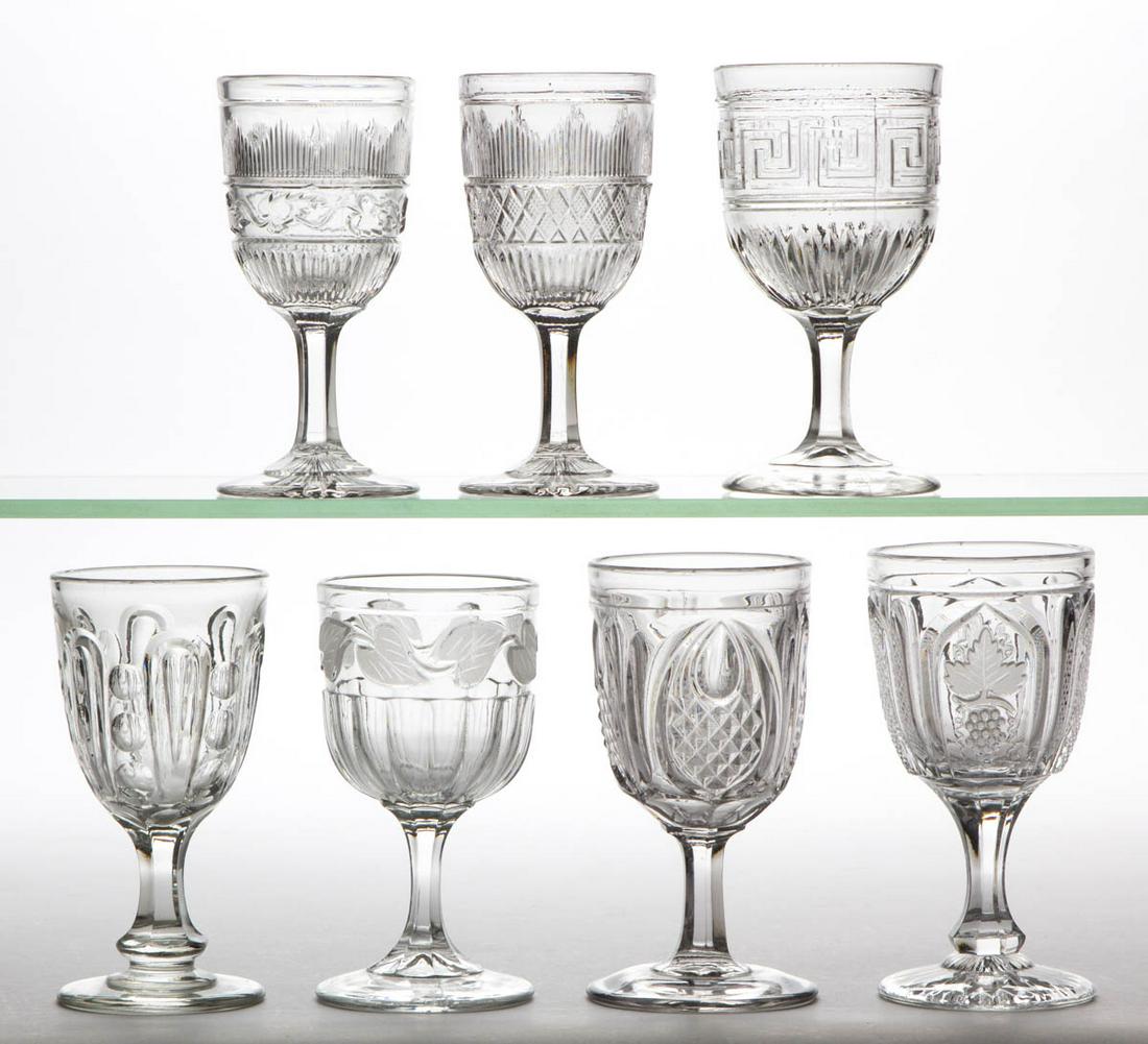 ASSORTED FLINT EAPG CHAMPAGNES, LOT OF SEVEN: ASSORTED FLINT EAPG CHAMPAGNES, LOT OF SEVEN, colorless lead glass, including a Roman Key lacking frosting, Frosted Leaf, New England Pineapple, and a Hamilton with Leaf. Various makers. Third quarter
