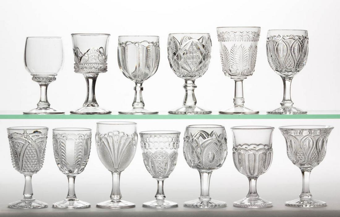 ASSORTED STATES PATTERN EAPG WINES, LOT OF 13: ASSORTED STATES PATTERN EAPG WINES, LOT OF 13, colorless, including a New Hampshire, Colorado, Pennsylvania, two New Jersey with one having a flaring rim, and a Massachusetts. U. S. Glass Co. Late 19t