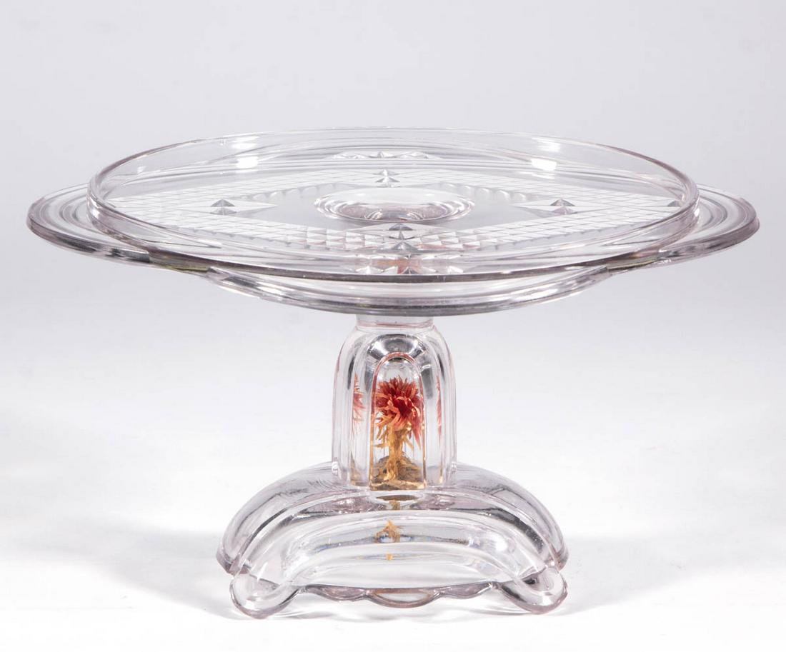 ADAMS NO. 120 (OMN) / OVAL TWO PANEL CAKE STAND /: ADAMS NO. 120 (OMN) / OVAL TWO PANEL CAKE STAND / SALVER, colorless, stem containing the original artificial flower and cork plug with partial Patent label. Adams & Company. 1884. 6 3/4" H, 12" DOA. U