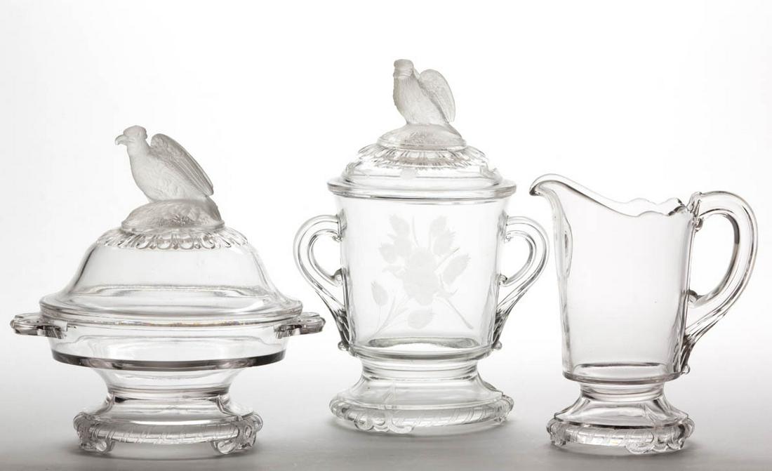 FROSTED EAGLE / OLD ABE TABLE ARTICLES, LOT OF THREE: FROSTED EAGLE / OLD ABE TABLE ARTICLES, LOT OF THREE, frosted and colorless, comprising a covered butter dish, covered sugar bowl with engraved decoration, and a creamer. Crystal Glass Co. Circa 1883.