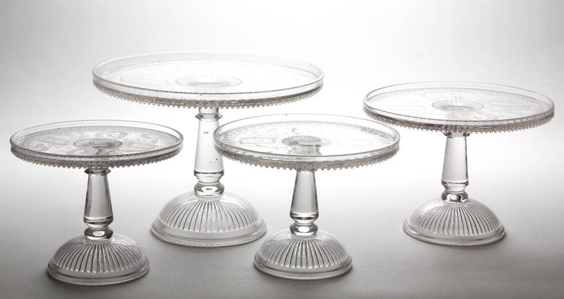 GOOD LUCK / HORSESHOE SALVERS / CAKE STANDS, LOT OF: GOOD LUCK / HORSESHOE SALVERS / CAKE STANDS, LOT OF FOUR, colorless. Fourth quarter 19th century. 6 1/2" to 8 5/8" H, 8" to 12" D rims. Largest example nearly undamaged with a single bead being flaked