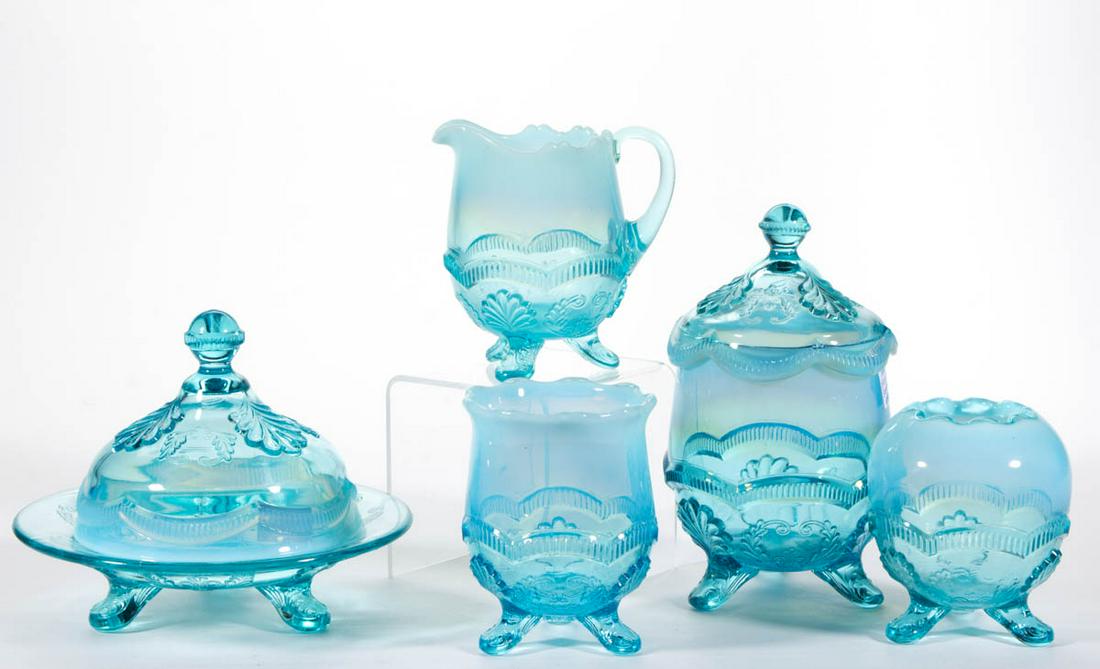 MANILA / WREATH AND SHELL TABLE ARTICLES, LOT OF FIVE: MANILA / WREATH AND SHELL TABLE ARTICLES, LOT OF FIVE, blue opalescent, comprising a covered butter dish, covered sugar bowl, creamer, spooner, and rose bowl. Model Flint Glass Co. 1899-1903. 4 1/8" t