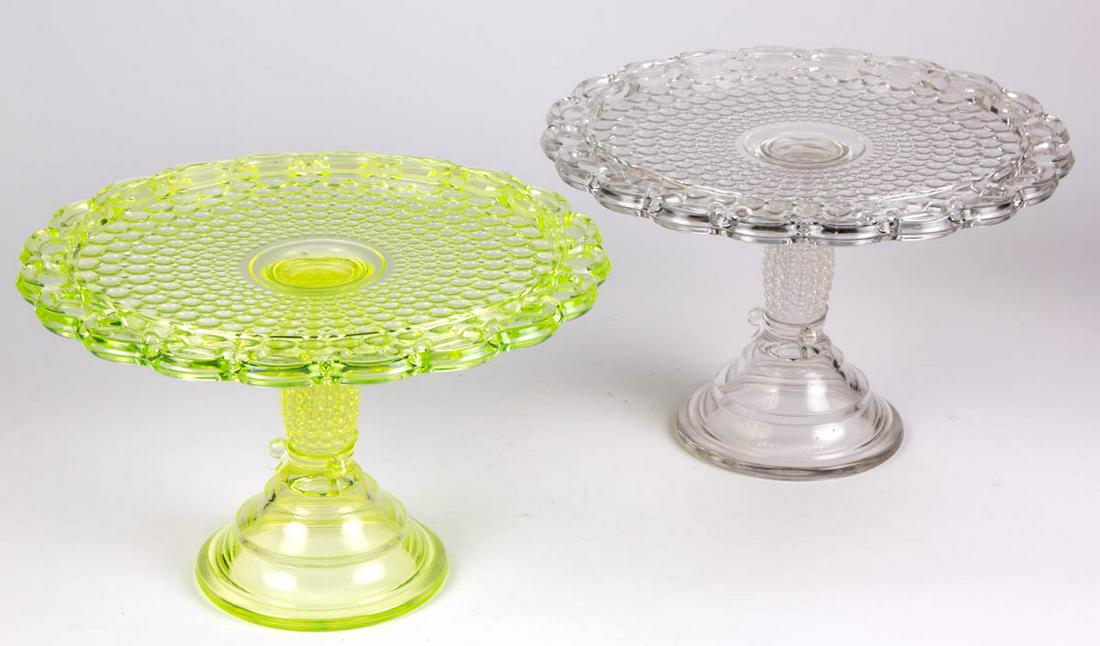 THOUSAND EYE / ADAMS NO. 130 SENSATION (OMN) SALVERS /: THOUSAND EYE / ADAMS NO. 130 SENSATION (OMN) SALVERS / CAKE STANDS, LOT OF TWO, colorless and Vaseline (reacts under black light). Adams & Co. Circa 1891. 6 5/8" H, 10" D rims. Undamaged with the colo
