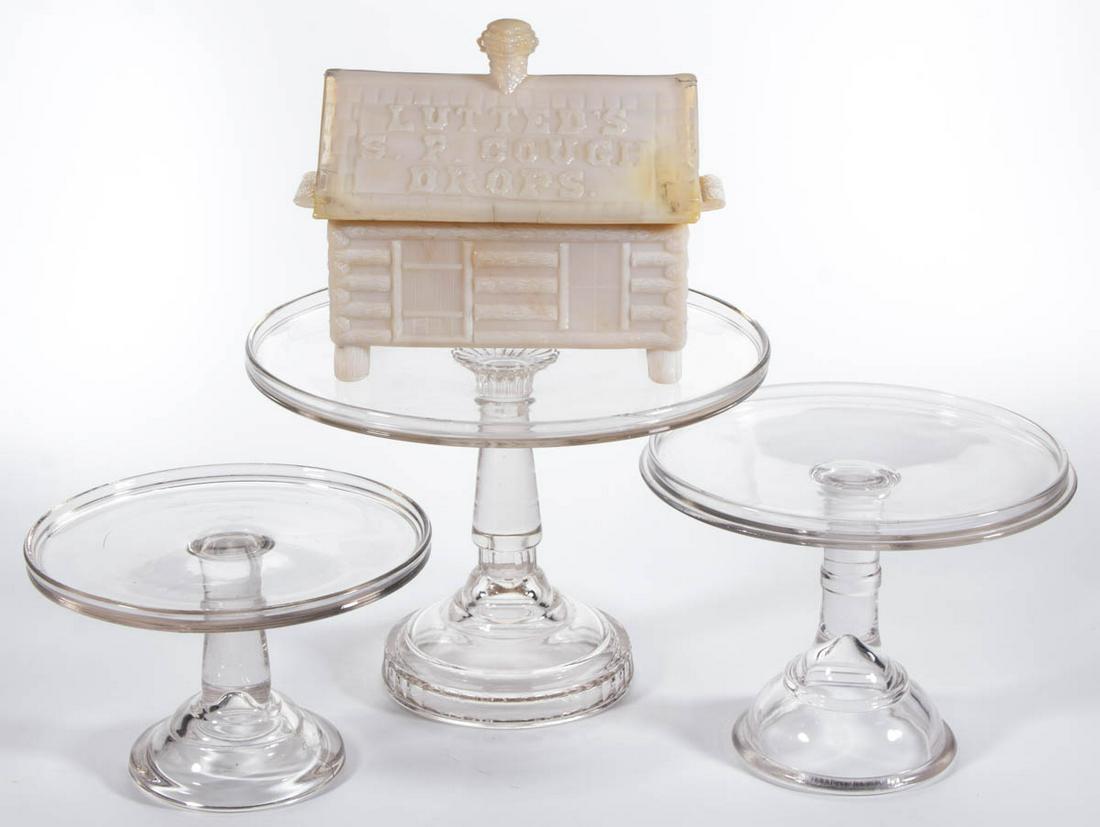 ASSORTED PRESSED GLASS SALVERS / CAKE STANDS, LOT OF: ASSORTED PRESSED GLASS SALVERS / CAKE STANDS, LOT OF THREE, colorless. Together with a reproduction peach opalescent "LUTTED'S/S.P. COUGH/DROPS" covered dish. Four pieces total. Various makers. 20th c
