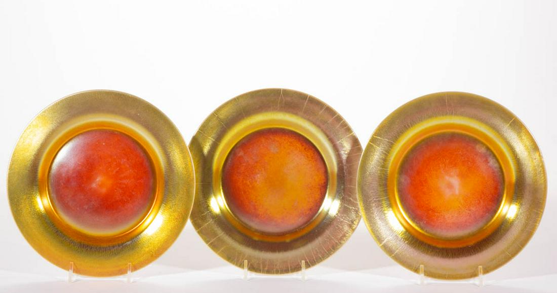STEUBEN CALCITE IRIDESCENT ART GLASS PLATES, LOT OF: STEUBEN CALCITE IRIDESCENT ART GLASS PLATES, LOT OF THREE, Gold Calcite. Steuben Glass Works. First quarter 20th century. 8 1/2" D.Undamaged.Provenance: From the Douglas Hare collection, Palmyra, NY.