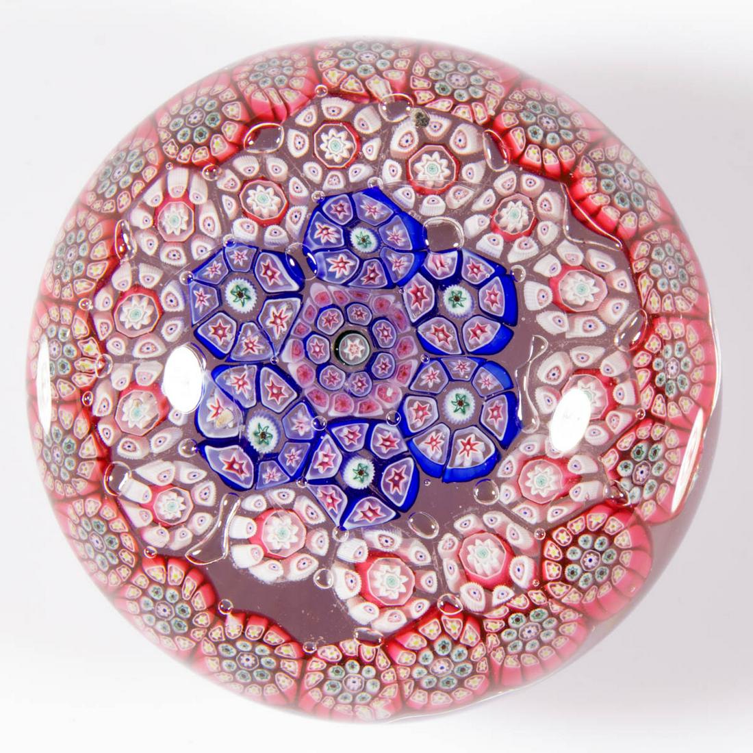 ANTIQUE CONCENTRIC MILLEFIORI PAPERWEIGHT: ANTIQUE CONCENTRIC MILLEFIORI PAPERWEIGHT, colorless, complex central cane with three additional rings of complex cogs, third row slightly out of line, polished pontil mark. Probably Bohemian. 19th ce