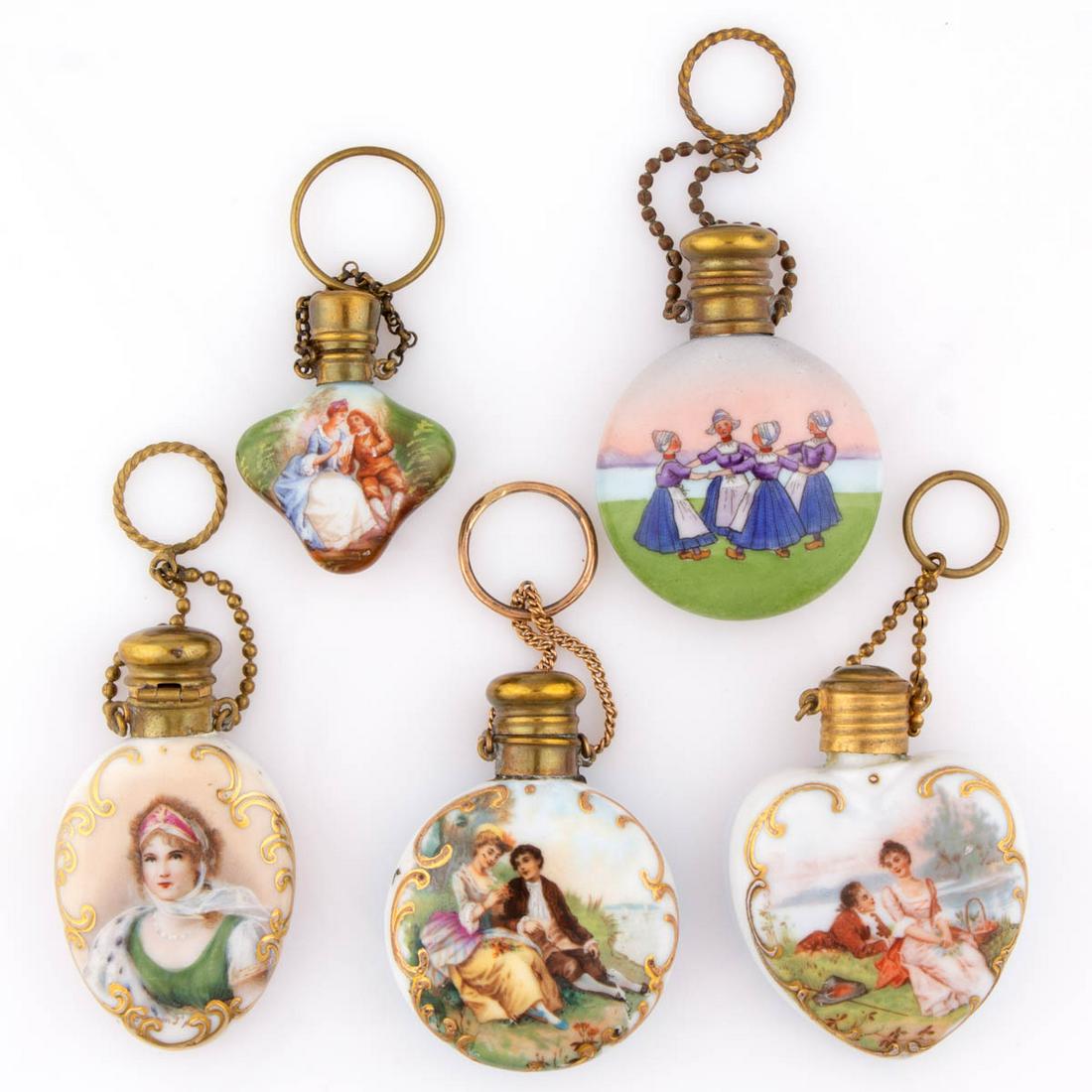 ASSORTED FIGURE MOTIF PORCELAIN SCENT BOTTLES, LOT OF: ASSORTED FIGURE MOTIF PORCELAIN SCENT BOTTLES, LOT OF FIVE, each having polychrome hand-painted decorations with metal fittings and a finger/chatelaine ring, comprising one featuring signed bust-lengt