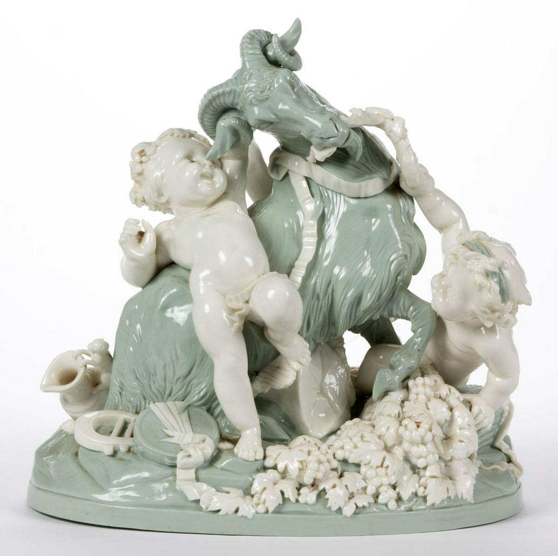 ENGLISH MINTON CELADON PORCELAIN FIGURAL GROUP: ENGLISH MINTON CELADON PORCELAIN FIGURAL GROUP, featuring three white-glazed playful putti, including one grasping cymbals, with a seafoam green-glazed horned goat on an oval base having scattered app