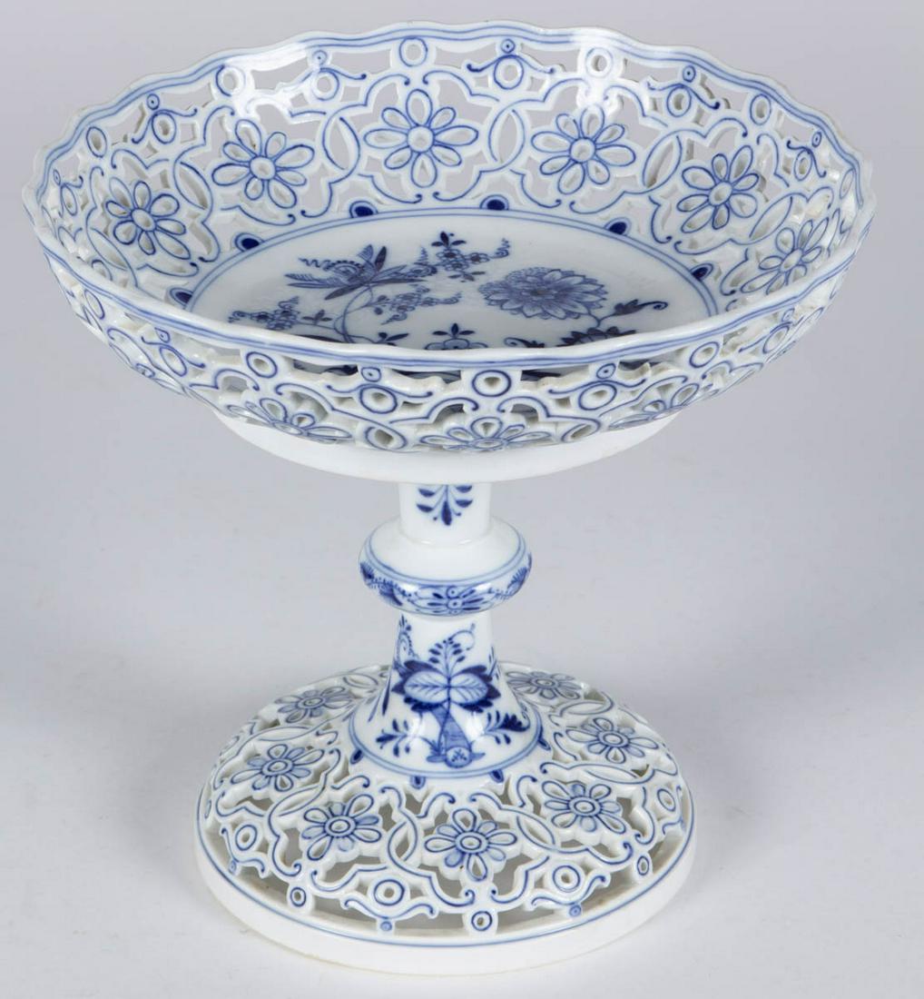 GERMAN MEISSEN BLUE ONION PORCELAIN RETICULATED COMPOTE: GERMAN MEISSEN BLUE ONION PORCELAIN RETICULATED COMPOTE, featuring stylized floral motif to center with scalloped rim and charming reticulated floral rim and foot. Having underglaze blue crossed sword