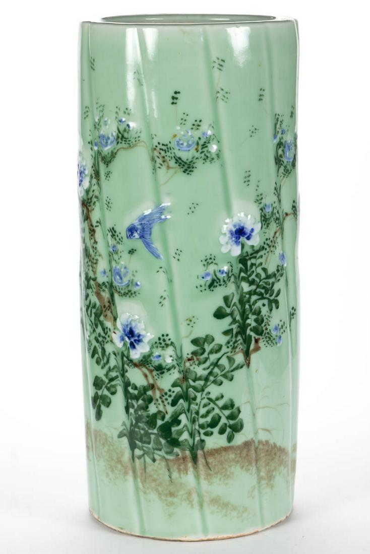 JAPANESE CELADON PORCELAIN UMBRELLA STAND: JAPANESE CELADON PORCELAIN UMBRELLA STAND, grooved cylindrical form, featuring polychrome hand-painted floral motif with bluebird on light green ground. Unmarked. First half 20th century. 23 3/4" H, 1
