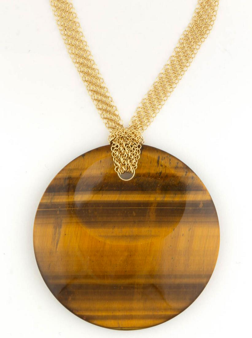 ELSA PERETTI FOR TIFFANY & CO. 18K YELLOW GOLD AND: ELSA PERETTI FOR TIFFANY & CO. 18K YELLOW GOLD AND TIGER'S EYE NECKLACE, having a large 50 mm round tiger's eye disc on a mesh necklace chain, including a Tiffany & Co. blue cloth pouch. Necklace mark