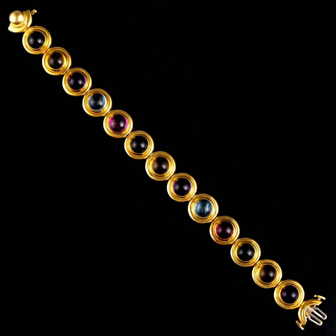 PALOMA PICASSO FOR TIFFANY & CO. 18K YELLOW GOLD AND: PALOMA PICASSO FOR TIFFANY & CO. 18K YELLOW GOLD AND GEMSTONE BRACELET, having 13 connected round links with 7.5 mm round stone cabochons including amethyst, aquamarine, and citrine, tab-insert clasp