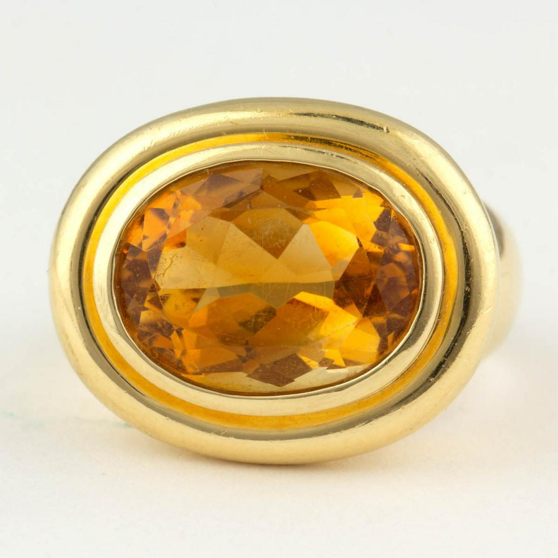 PALOMA PICASSO FOR TIFFANY & CO. 18K YELLOW GOLD AND: PALOMA PICASSO FOR TIFFANY & CO. 18K YELLOW GOLD AND CITRINE RING, having a 15.5 x 11.5 mm oval-cut citrine in bezel setting on a plain band. Interior band marked "Paloma Picasso" and "TIFFANY & CO. 7