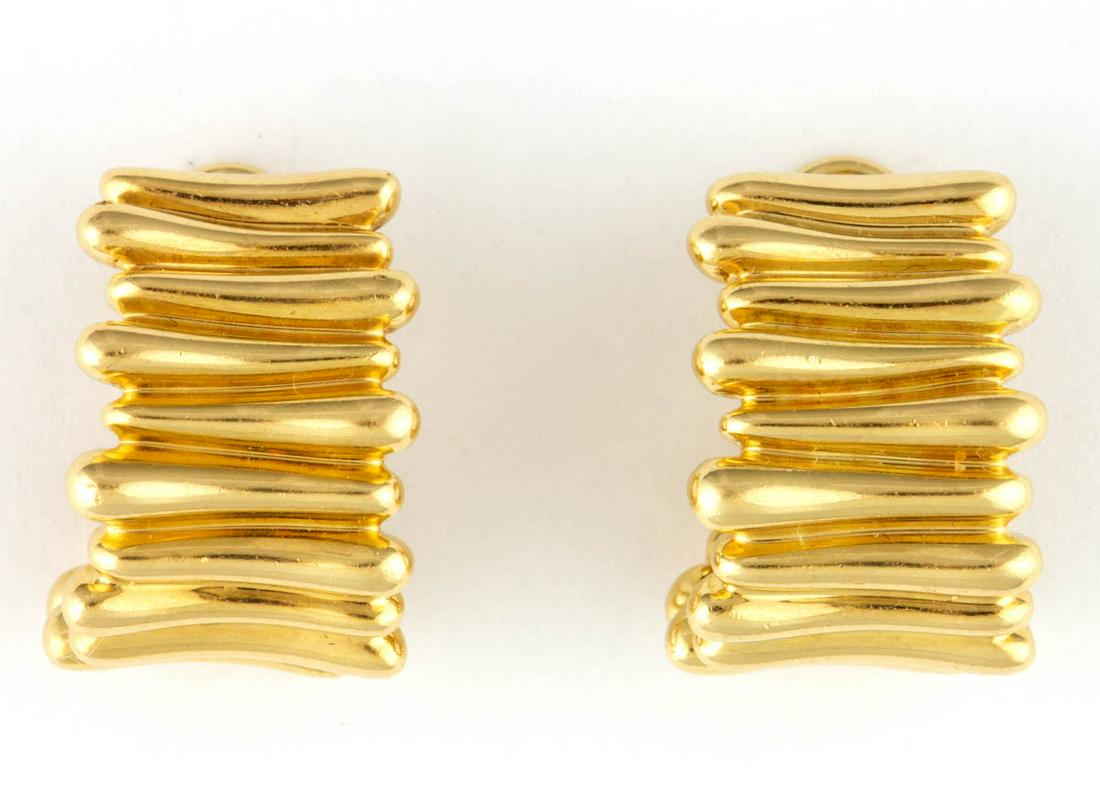TIFFANY & CO. 18K YELLOW GOLD EARRINGS, PAIR: TIFFANY & CO. 18K YELLOW GOLD EARRINGS, PAIR, each partial hoop with linear design, post back with omega clip fastener. Each marked "(c) 2002 T & Co. 750". Total weight: 10.2 dwt. 21st century. Each 3