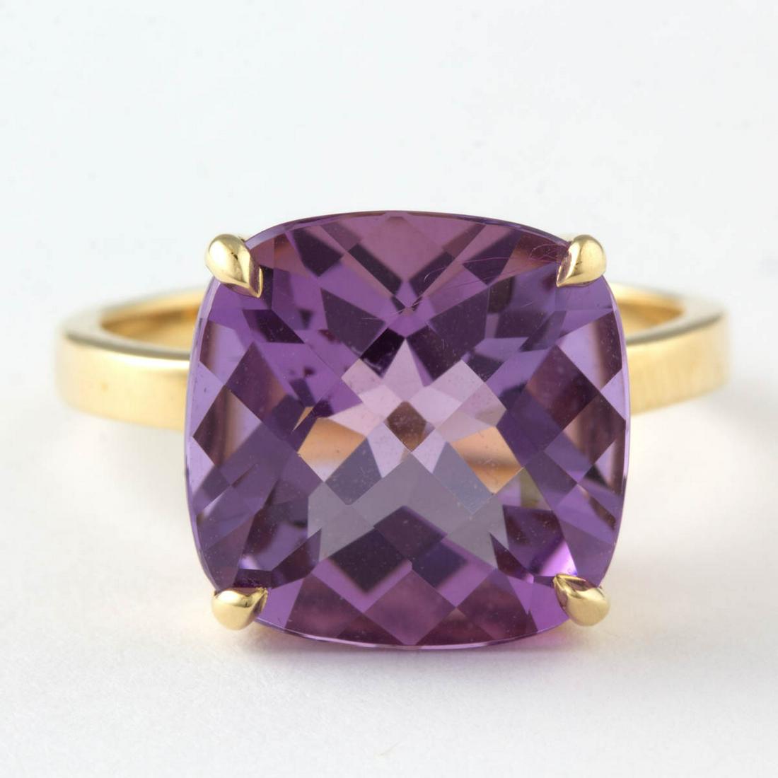 TIFFANY & CO. 18K YELLOW GOLD AND AMETHYST SOLITAIRE: TIFFANY & CO. 18K YELLOW GOLD AND AMETHYST SOLITAIRE RING, having a 14 x 14 mm checkerboard-cut amethyst in four-prong setting on a plain band. Interior band marked "(c) TIFFANY & CO." and "750". Tota