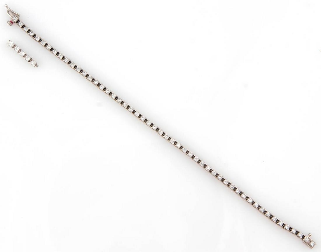 CHRISTIAN CAINE DESIGN 14K WHITE GOLD AND DIAMOND: CHRISTIAN CAINE DESIGN 14K WHITE GOLD AND DIAMOND TENNIS BRACELET, having square links and a hidden tab insert clasp with safety, set with 51 2.0 mm D round brilliant-cut diamonds and a 5/8" section w