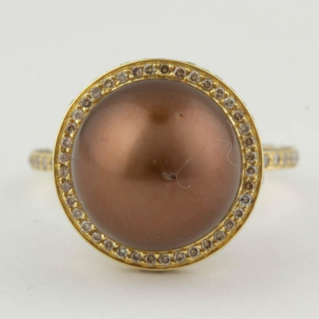 IRIDESSE BY TIFFANY & CO. 18K GOLD, DIAMOND, AND PEARL: IRIDESSE BY TIFFANY & CO. 18K GOLD, DIAMOND, AND PEARL RING, having a 13.6 mm brown-colored pearl in a halo setting, setting and shoulders encrusted by melee diamonds. Interior band with slightly worn