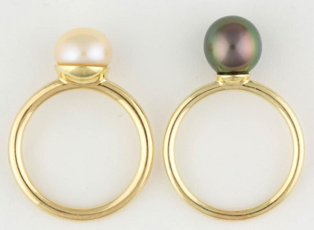 IRIDESSE BY TIFFANY & CO. 18K YELLOW GOLD AND PEARL: IRIDESSE BY TIFFANY & CO. 18K YELLOW GOLD AND PEARL RINGS, LOT OF TWO, comprising one with a 9.4 mm white pearl, and one with a 9.4-9.8mm grey pearl, each with plain band. Each marked "IRIDESSE" and "