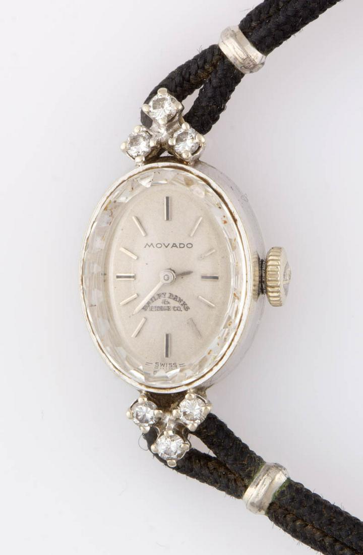 VINTAGE MOVADO 14K GOLD AND DIAMOND CASE LADY'S WRIST: VINTAGE MOVADO 14K GOLD AND DIAMOND CASE LADY'S WRIST WATCH, Movado Swiss 17-jewel movement with winding mechanism, housed in a 14K white gold case with crystal, embellished by six 2.0 mm round brilli