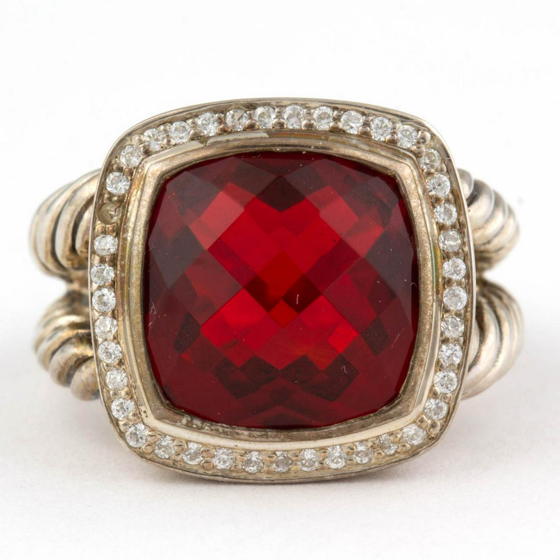 DAVID YURMAN STERLING SILVER AND GARNET SOLITAIRE RING: DAVID YURMAN STERLING SILVER AND GARNET SOLITAIRE RING, having a 14 mm square checkerboard-cut red garnet surrounded by a hallow of colorless melee stones, on a split-shank cable band. Marked "(c) D. 