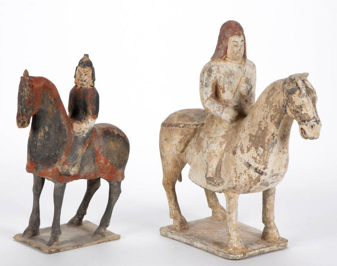CHINESE EARTHENWARE HORSE AND RIDER TOMB FIGURES, LOT: CHINESE EARTHENWARE HORSE AND RIDER TOMB FIGURES, LOT OF TWO, each having remnants of pigment and horses attached to rectangular base, comprising taller example possibly from the Eastern Wei Dynasty, 